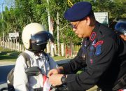 Sambut HUT RI ke-80, Brimob Polda Sultra Bagikan dan Pasangkan Bendera kepada Pengguna Jalan